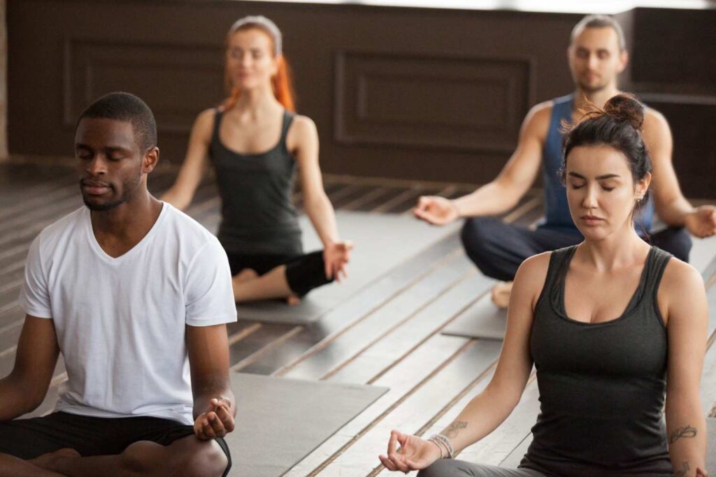 Group Young Sporty People Meditating Easy Seat Pose 1024x683
